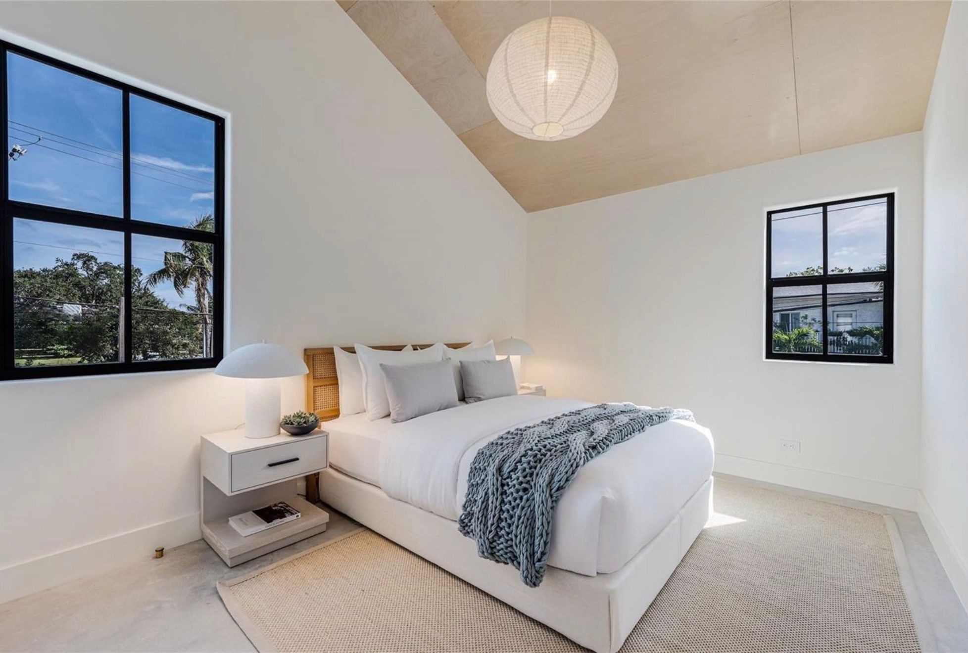 Bedroom with vaulted plywood ceiling
